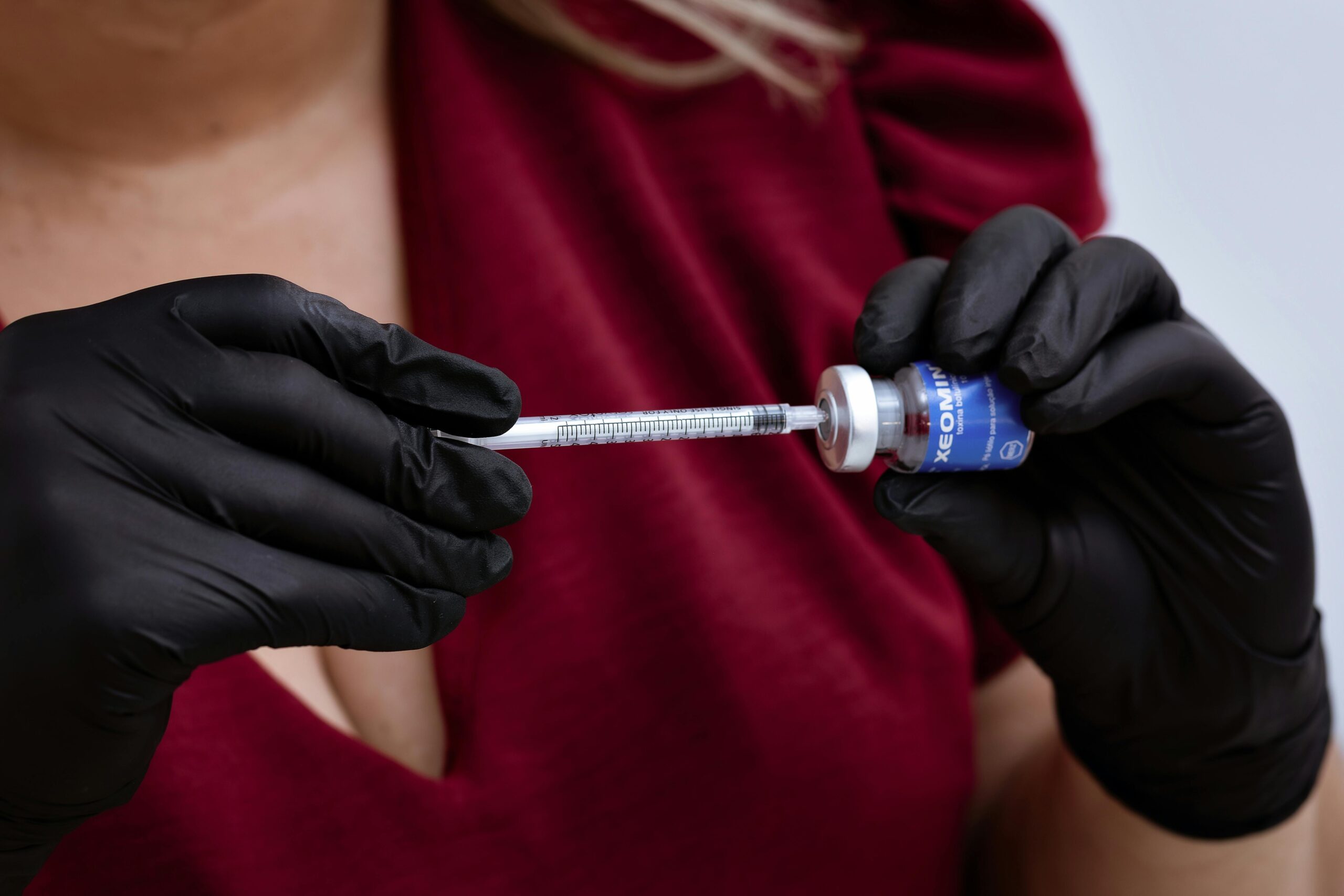 A person holding a bottle of Botox in her hand