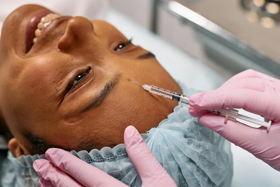 A healthcare professional giving botox injection services to a patient